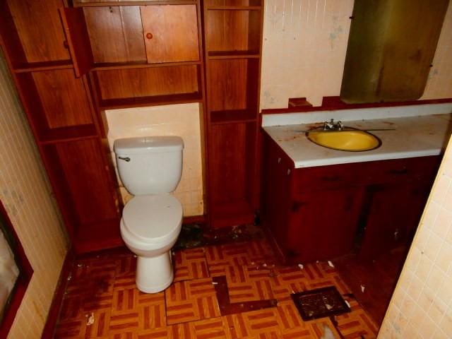 half bathroom with toilet and vanity