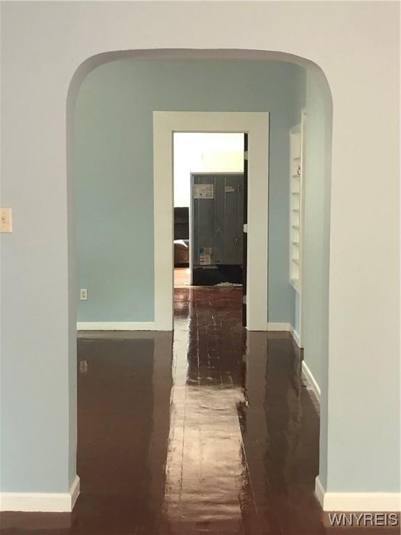 202 Thompson St, Buffalo, NY 14207 - corridor featuring wood finished floors, arched walkways, and baseboards