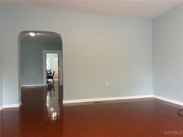 202 Thompson St, Buffalo, NY 14207 - unfurnished room with arched walkways, hardwood / wood-style flooring, and baseboards