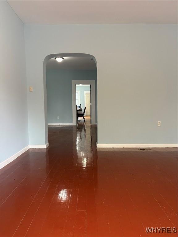 202 Thompson St, Buffalo, NY 14207 - unfurnished room featuring arched walkways, wood-type flooring, and baseboards