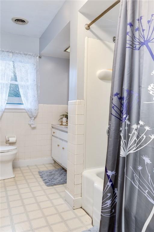 31 Briarcliff Dr, Horseheads, NY 14845 - full bath featuring tile patterned floors, visible vents, toilet, vanity, and tile walls