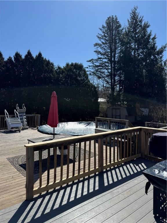31 Briarcliff Dr, Horseheads, NY 14845 - wooden deck featuring an outdoor structure and a storage unit