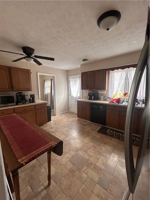 31 Briarcliff Dr, Horseheads, NY 14845 - kitchen with a ceiling fan, dishwasher, stone tile flooring, light countertops, and stainless steel microwave