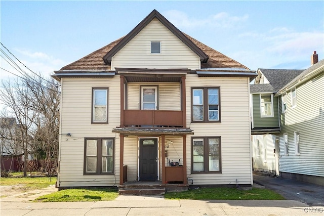 townhome / multi-family property with a shingled roof