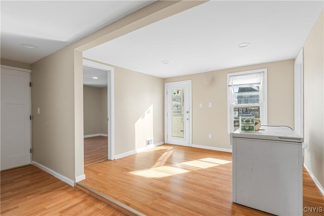 entrance foyer with light wood finished floors and baseboards
