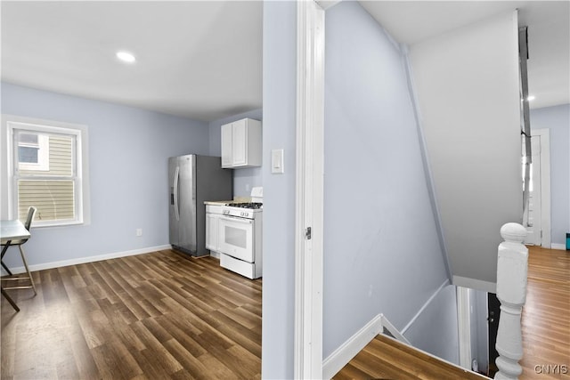 kitchen featuring dark wood finished floors, white cabinetry, white range with gas stovetop, and stainless steel refrigerator with ice dispenser
