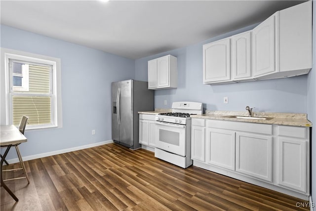 kitchen with white gas range, white cabinetry, a sink, stainless steel fridge with ice dispenser, and dark wood-style floors