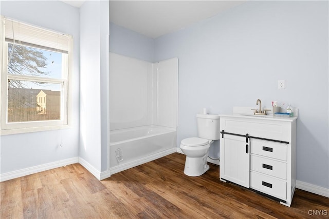 full bathroom featuring toilet, vanity, baseboards, and wood finished floors