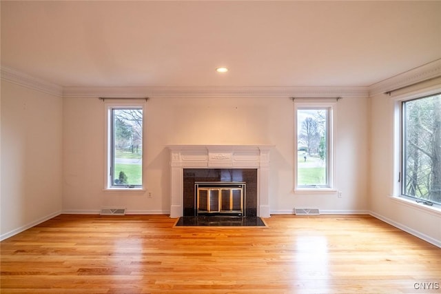 unfurnished living room with ornamental molding, visible vents, and wood finished floors