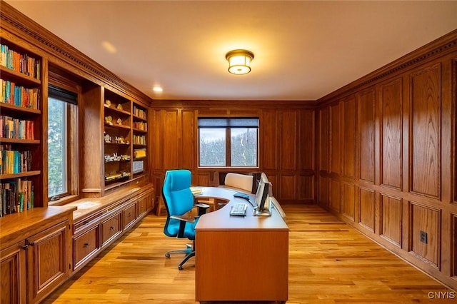 office featuring light wood-style flooring and wood walls