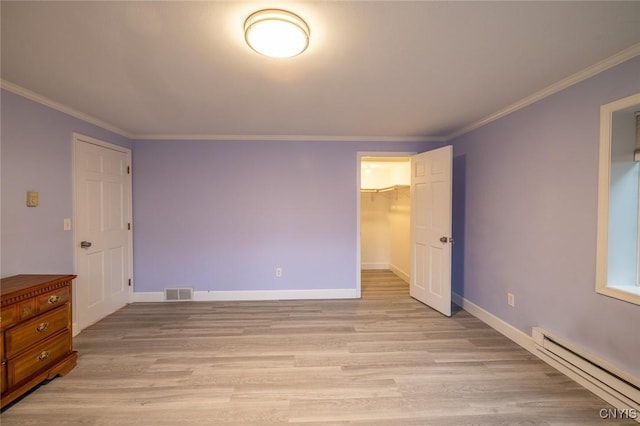 bedroom featuring visible vents, a baseboard radiator, baseboards, ornamental molding, and light wood-type flooring