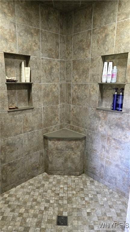 bathroom with a tile shower