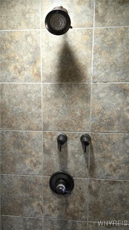 details with a tile shower