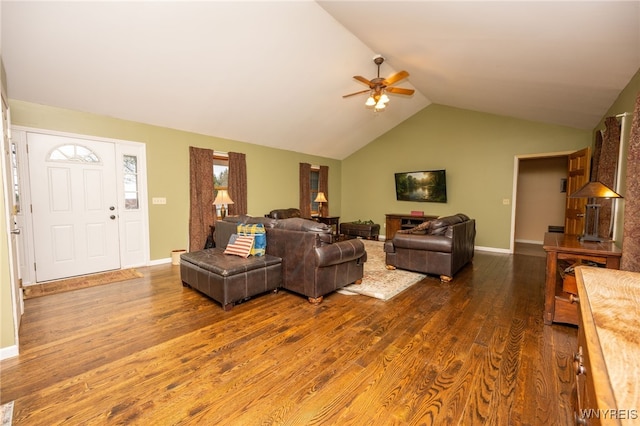 living room featuring dark wood finished floors, lofted ceiling, a ceiling fan, and baseboards