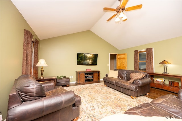 living area with vaulted ceiling, baseboards, and ceiling fan