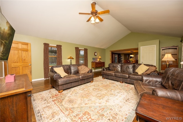 living room with ceiling fan, vaulted ceiling, and wood finished floors