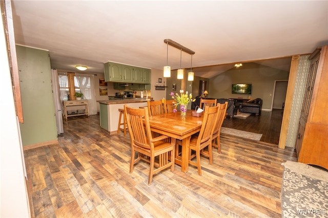 dining space featuring baseboards and wood finished floors