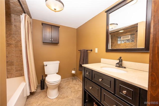 bathroom featuring tile patterned flooring, toilet, vanity, baseboards, and shower / bath combo