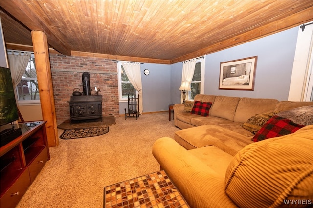 carpeted living area featuring wood ceiling and a wood stove