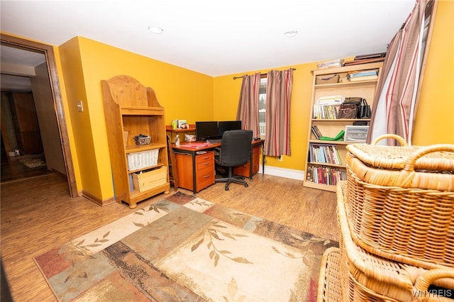 office featuring baseboards, light wood finished floors, and recessed lighting