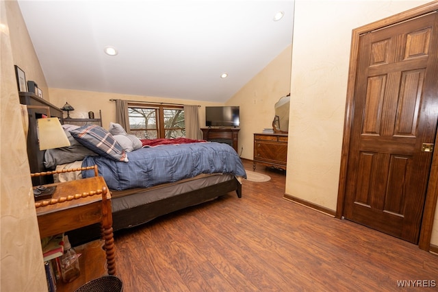 bedroom with recessed lighting, vaulted ceiling, wood finished floors, and baseboards