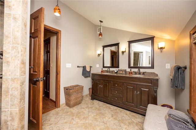 full bath featuring lofted ceiling, tile patterned floors, a sink, and double vanity