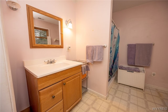 bathroom with radiator, baseboards, vanity, and visible vents