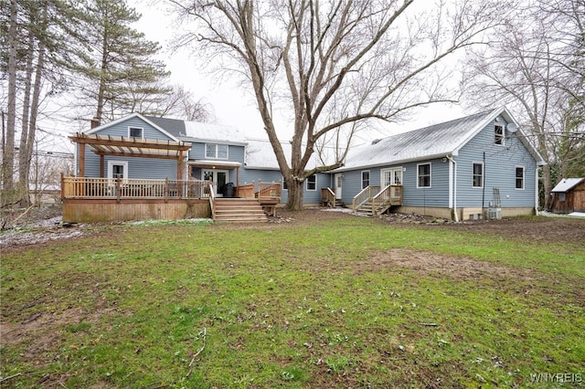 rear view of property with a lawn, a pergola, and a deck