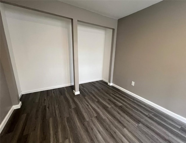 200 Henry St, Montour, NY 14865 - unfurnished bedroom with a closet, baseboards, and dark wood finished floors