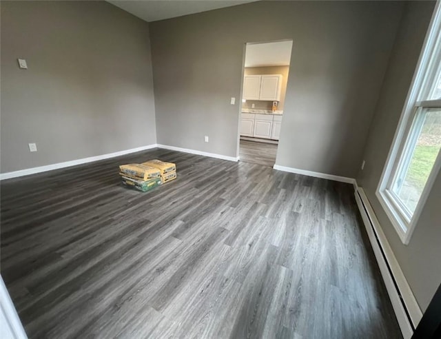 200 Henry St, Montour, NY 14865 - empty room featuring baseboards, a baseboard heating unit, lofted ceiling, and dark wood finished floors