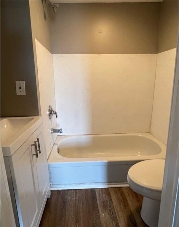 200 Henry St, Montour, NY 14865 - full bathroom with toilet, wood finished floors, vanity, and a tub to relax in
