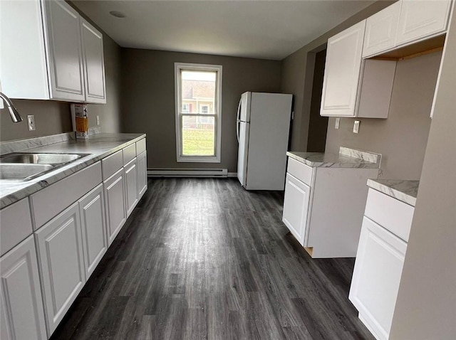 200 Henry St, Montour, NY 14865 - kitchen featuring white cabinets, a sink, light countertops, freestanding refrigerator, and baseboard heating