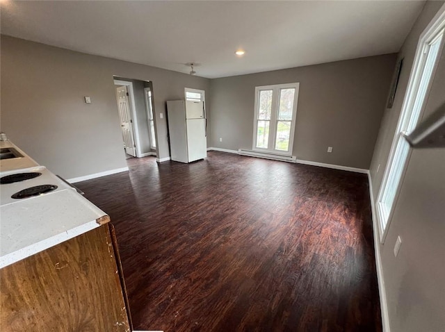 200 Henry St, Montour, NY 14865 - unfurnished living room with a sink, dark wood-type flooring, a baseboard heating unit, and baseboards