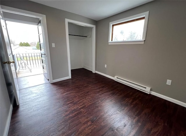 200 Henry St, Montour, NY 14865 - unfurnished bedroom featuring access to outside, a closet, wood finished floors, a baseboard heating unit, and baseboards