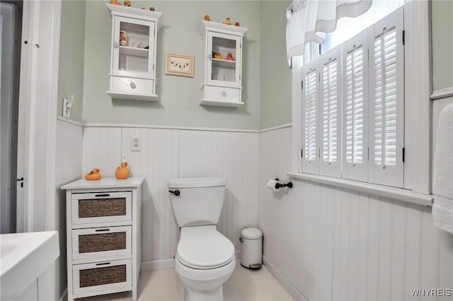 2831 S Park Ave, Lackawanna, NY 14218 - bathroom with toilet, a wainscoted wall, and tile patterned flooring