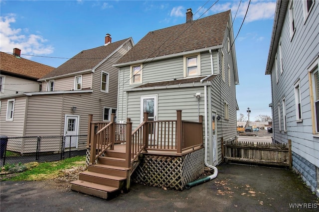 2831 S Park Ave, Lackawanna, NY 14218 - rear view of house with a deck, a chimney, a shingled roof, and fence