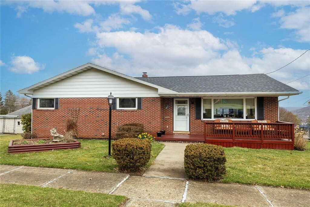 343 W 3rd St, Corning City, NY 14830 - view of front of house with a porch, roof with shingles, a front yard, and brick siding
