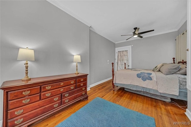 bedroom with crown molding, wood-type flooring, baseboards, and a ceiling fan