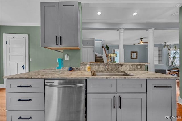 kitchen featuring dishwasher, a sink, a peninsula, crown molding, and gray cabinets