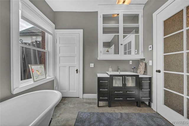 39 Days Park, Buffalo, NY 14201 - bathroom featuring a soaking tub, vanity, and baseboards