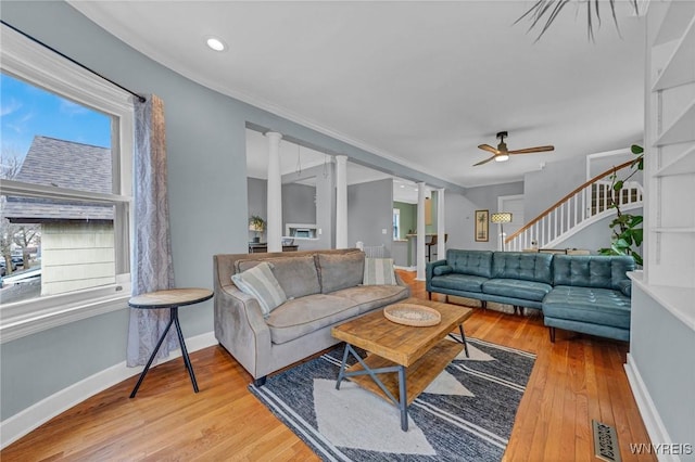 39 Days Park, Buffalo, NY 14201 - living room featuring wood-type flooring, stairway, a ceiling fan, baseboards, and ornate columns