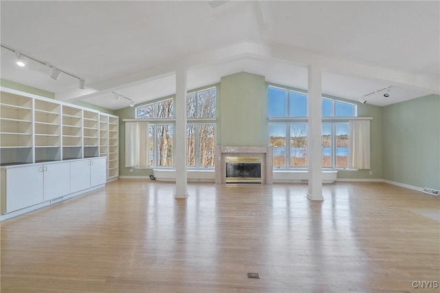 3158 W Lake Rd, Cazenovia, NY 13035 - unfurnished living room featuring a tiled fireplace, wood finished floors, and lofted ceiling