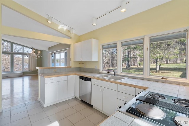 3158 W Lake Rd, Cazenovia, NY 13035 - kitchen with an inviting chandelier, a peninsula, lofted ceiling, stainless steel dishwasher, and a sink