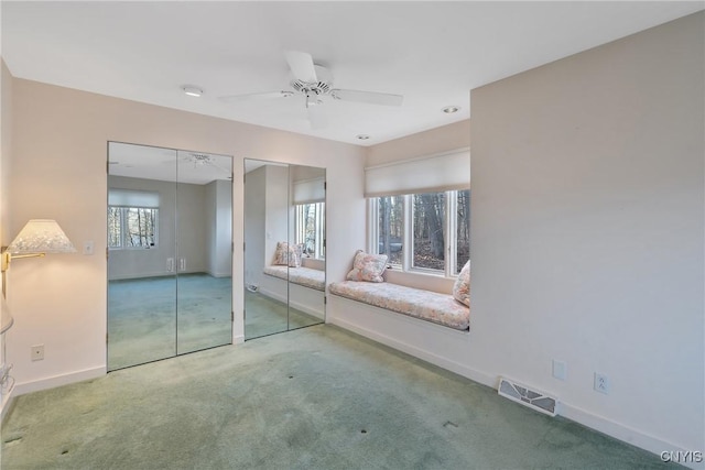 3158 W Lake Rd, Cazenovia, NY 13035 - unfurnished bedroom with carpet, multiple windows, and multiple closets