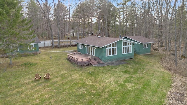 3158 W Lake Rd, Cazenovia, NY 13035 - back of property featuring roof with shingles, a deck, and a lawn