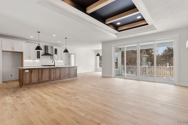 unfurnished living room featuring recessed lighting, baseboards, ornamental molding, and light wood-type flooring
