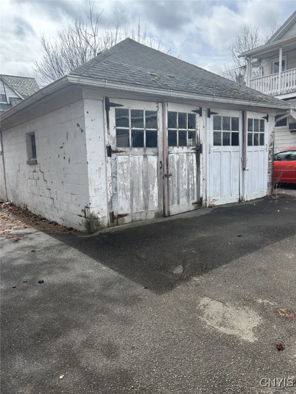 482 Roe Ave, Elmira-City, NY 14901 - exterior space with concrete block siding and roof with shingles