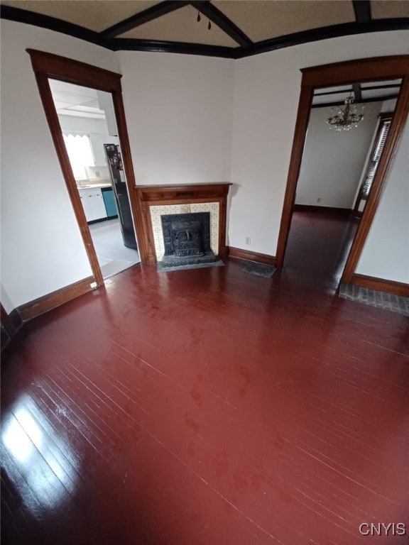 482 Roe Ave, Elmira-City, NY 14901 - unfurnished living room featuring baseboards, a chandelier, wood finished floors, and a fireplace