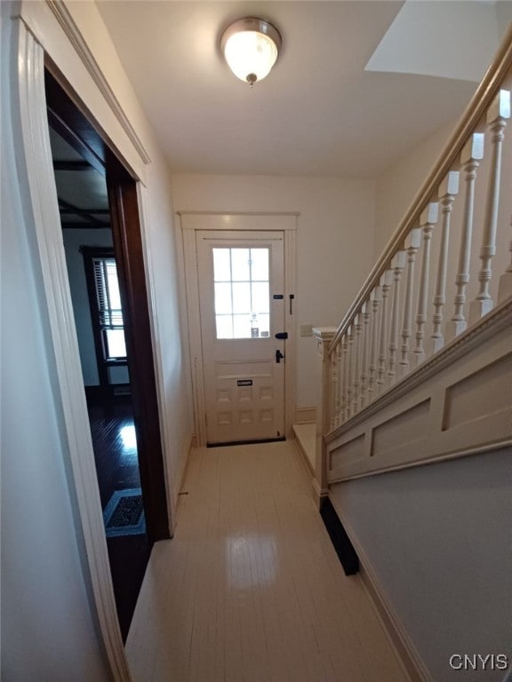 482 Roe Ave, Elmira-City, NY 14901 - doorway with stairs, light wood finished floors, and baseboards