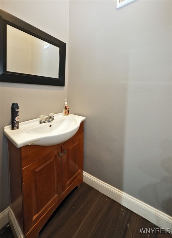 894 Tonawanda St, Buffalo, NY 14207 - bathroom with vanity, baseboards, and wood finished floors
